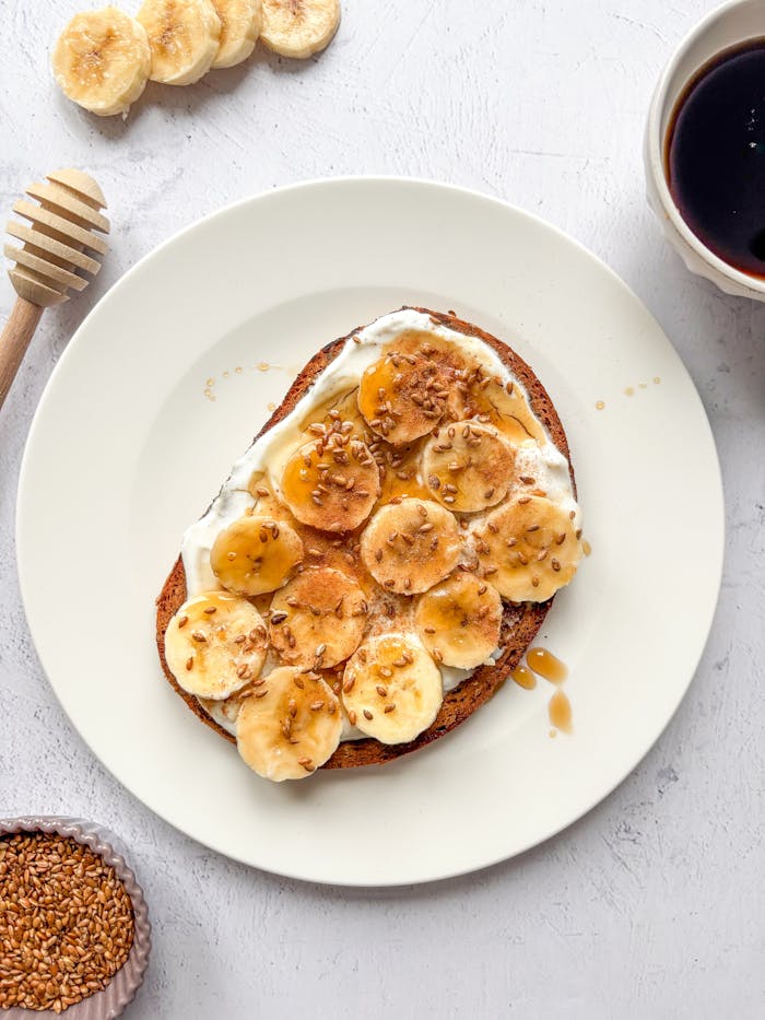 Tasty banana toast with honey, topped with seeds, perfect for breakfast.