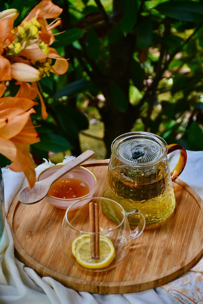 services-04 A warm herbal tea setup outdoors with honey, lemon, and flowers. Perfect for a cozy, nature-inspired experience.